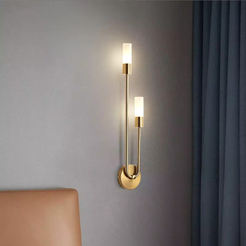 Spire sleek LED wall light in golden brass finish with two white cylindrical shades, modern minimalist design UK