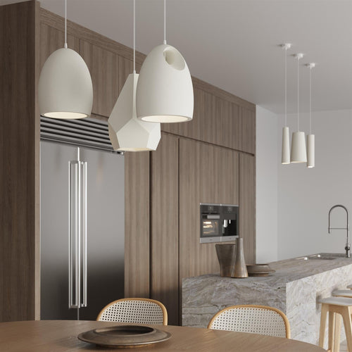 White ceramic pendant lights with modern geometric shapes hanging in contemporary kitchen interior