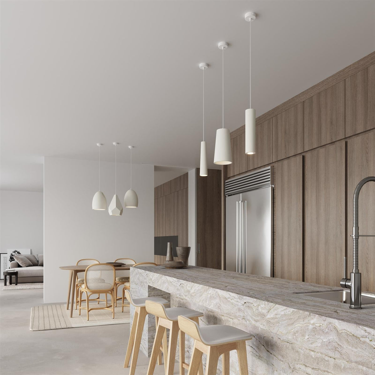 White ceramic cylindrical pendant lights hanging over marble kitchen island in modern minimalist interior