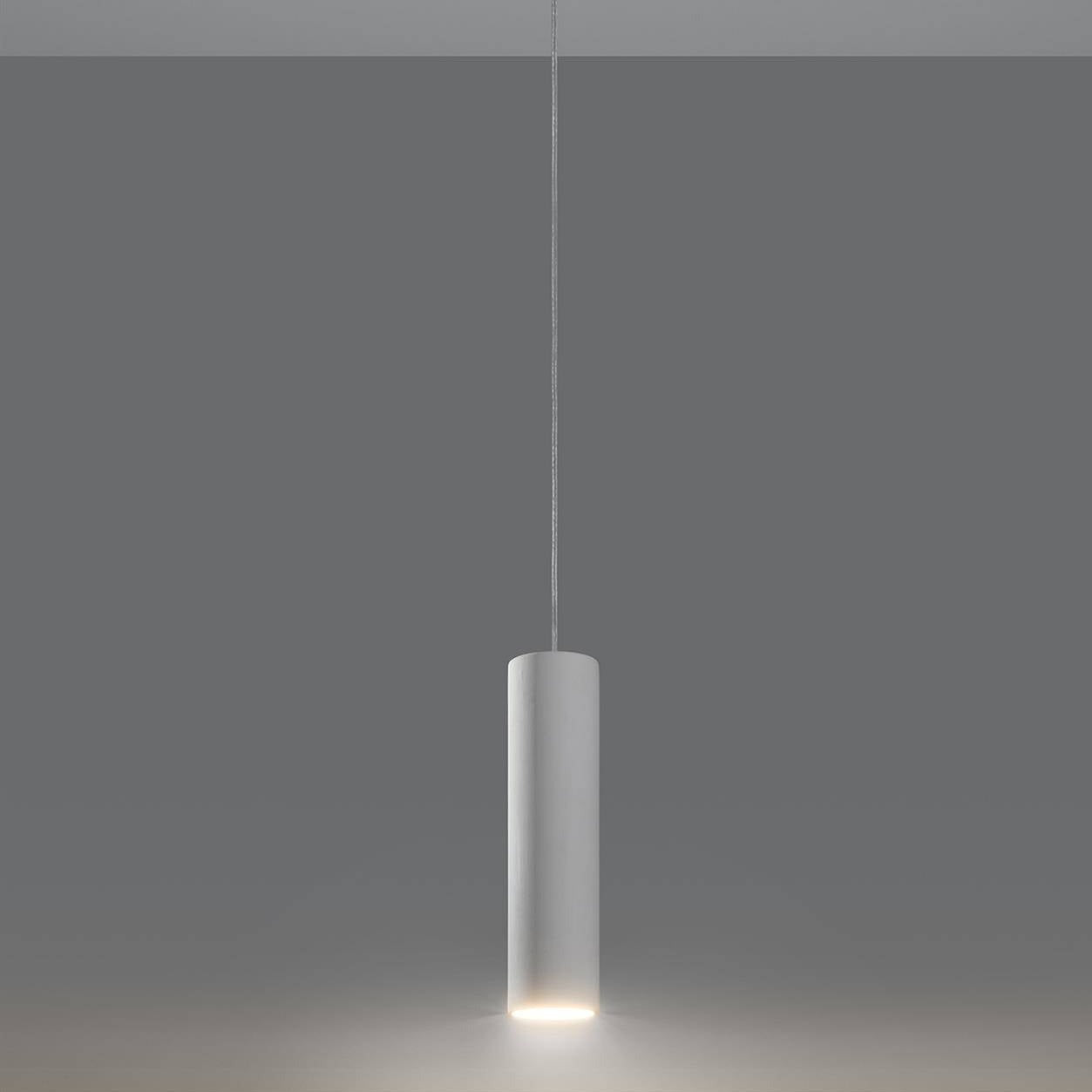 White ceramic tube pendant light hanging against grey background showing minimalist cylindrical design with warm LED glow