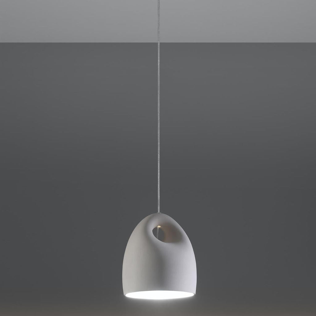 White ceramic pendant light with curved handle detail, matte finish, modern minimalist design, suspended from ceiling