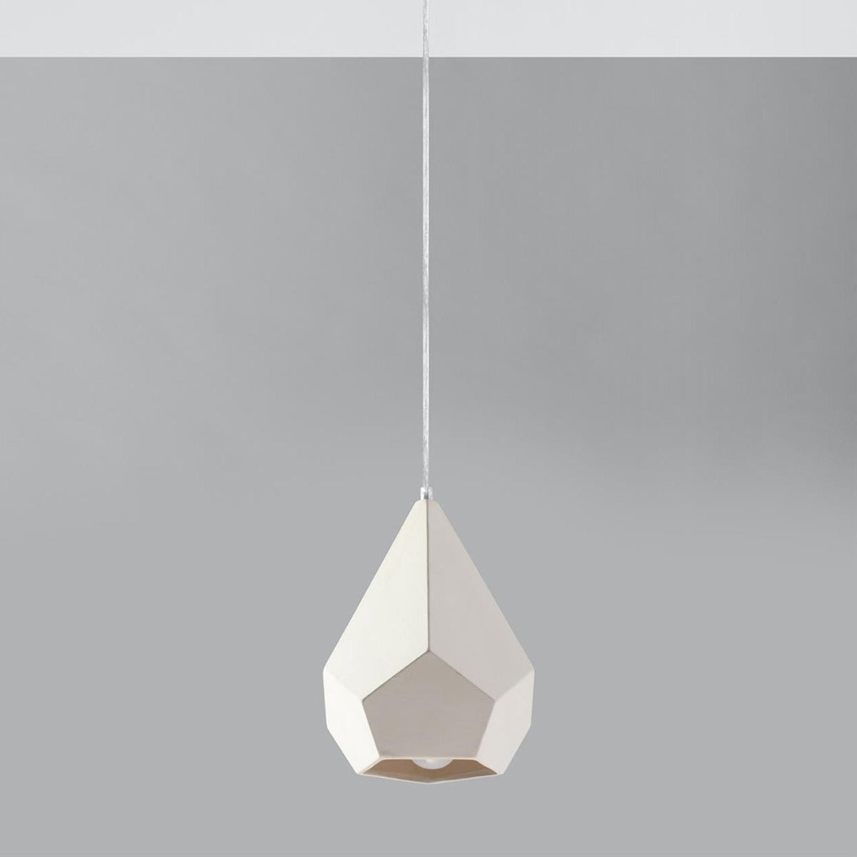 White ceramic geometric pendant light with faceted teardrop design and brass interior - modern hanging lamp fixture UK