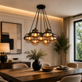 Dining room with a modern bubble chandelier, table setting, and decor elements.