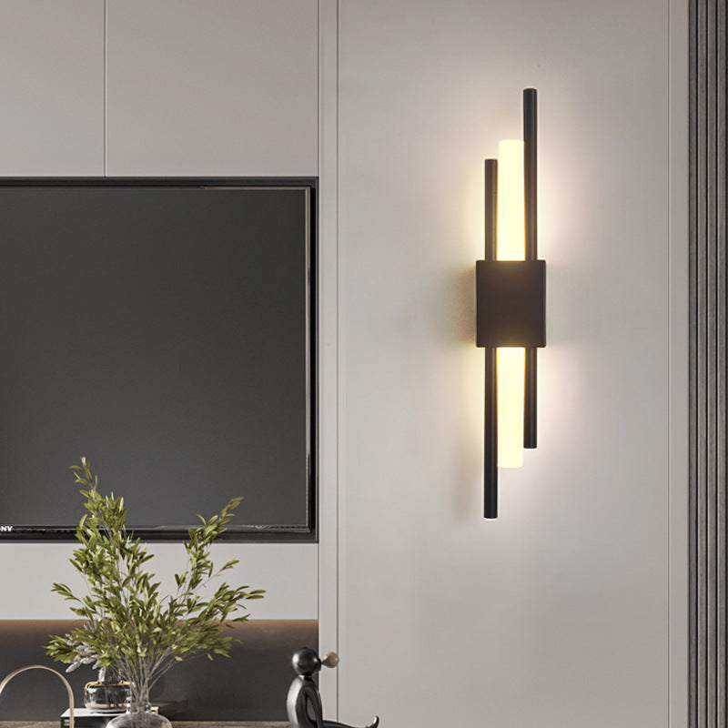 Black LED wall lamp with vertical light strips in modern living room, warm white glow, contemporary geometric design