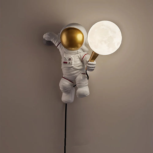 White astronaut wall light with golden helmet holding LED moon globe, plug-in kids bedroom lighting UK
