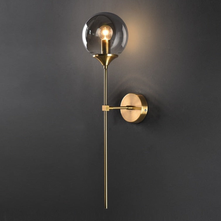 Sizzle smoke glass wall light with brass finish and long stem mount, modern sconce lighting UK - angled view