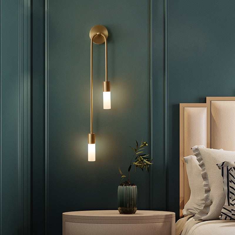 Spire Sleek wall light installed in a minimalist bedroom setting, mounted at eye level beside a bed headboard