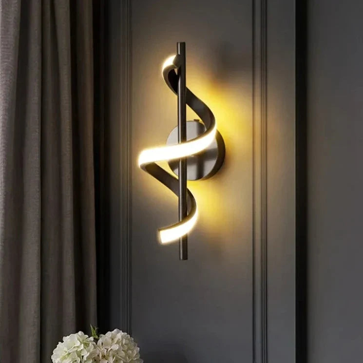 Modern black twisted LED wall light with warm glow mounted on grey wall, spiral design sconce for contemporary home lighting