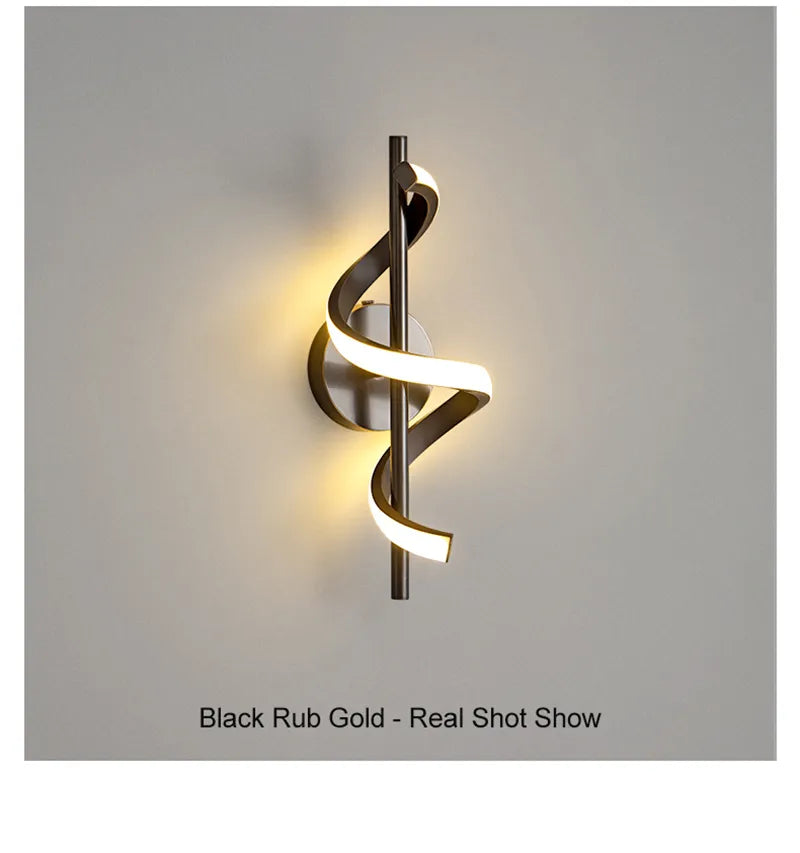 Modern twisted LED wall light in black rubbed gold finish showing spiral ribbon design against white wall