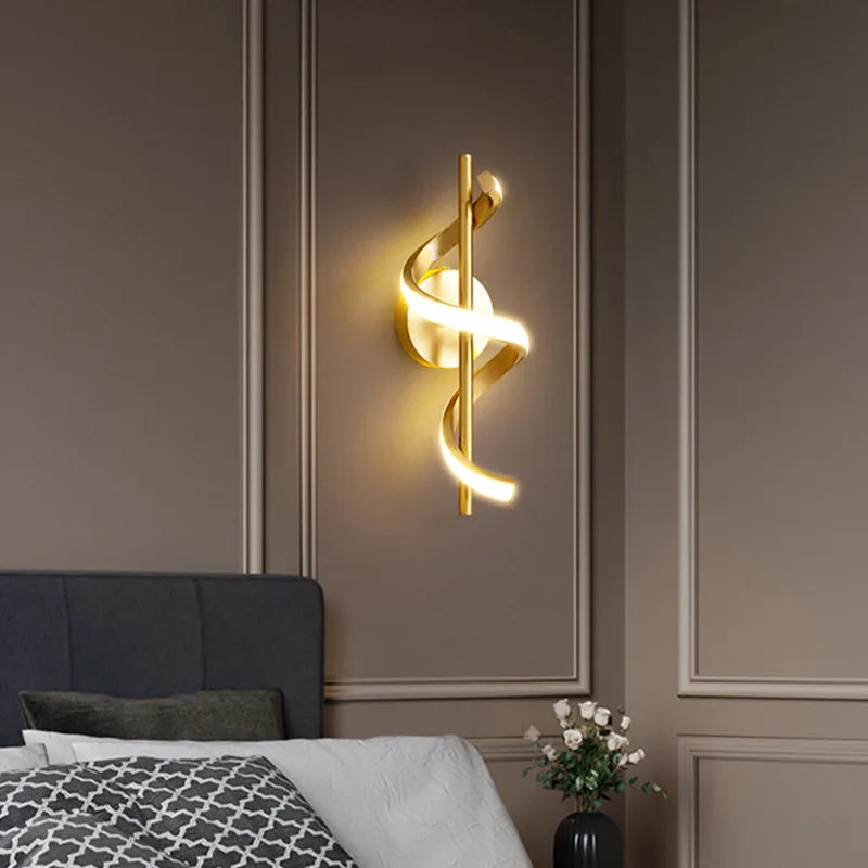 Twisted LED wall light in copper gold finish mounted on bedroom wall, spiral design with warm white lighting
