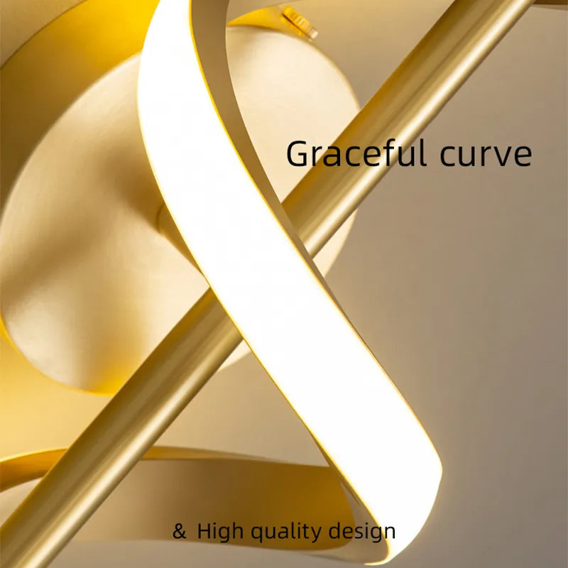 Modern twisted LED wall light with gold brass finish showing curved sculptural design and warm white illumination